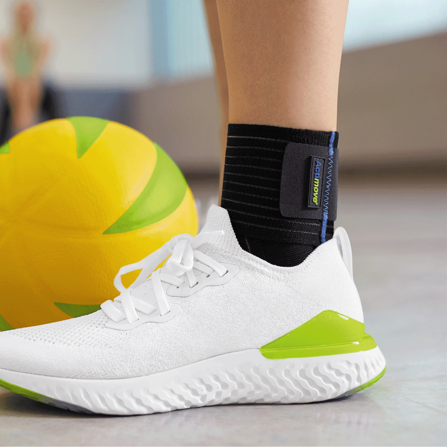 Close-up lifestyle image of someone wearing the Actimove Sport Ankle Support Elastic Wrap Around around ankle while engaging in sports