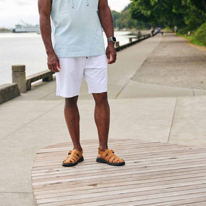 Pete Rodríguez standing on a dock wearing the Propet sandals footwear in Tan