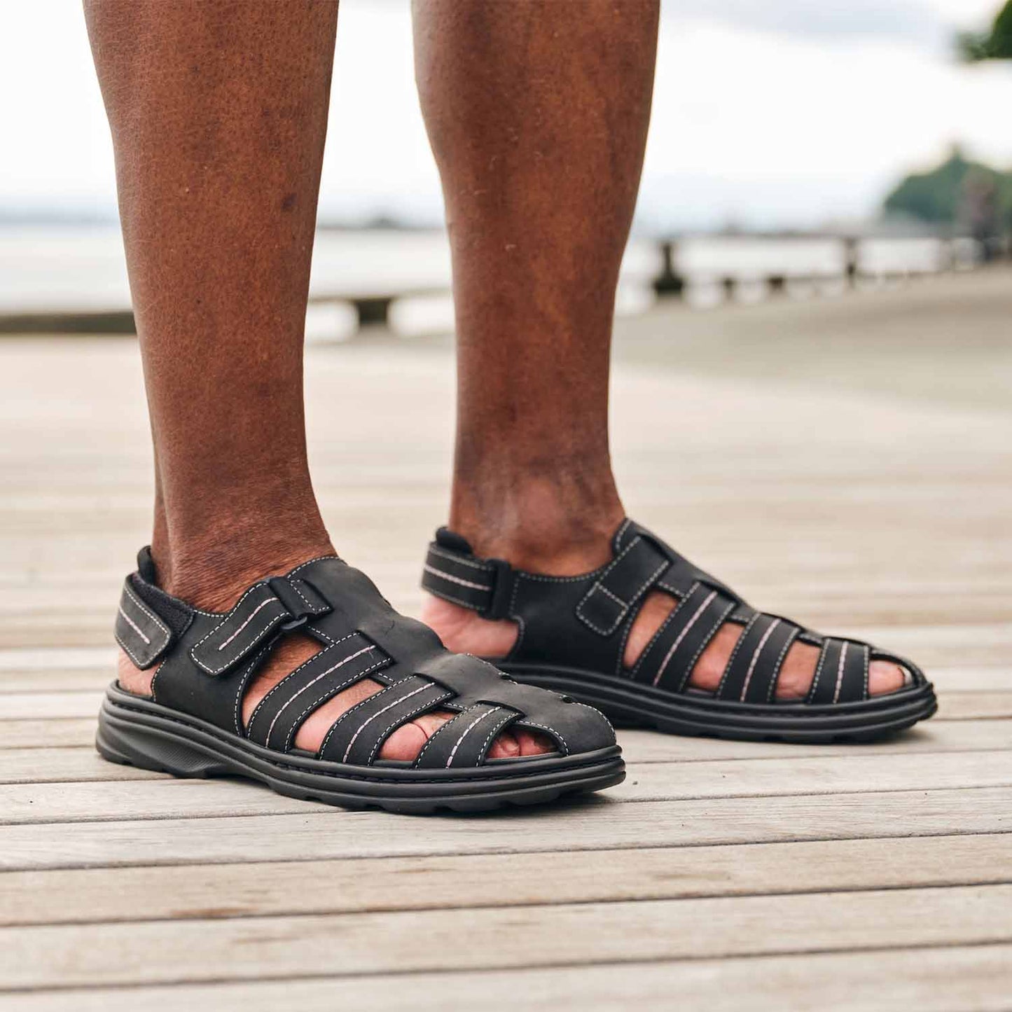 Close-up of man's legs wearing the Men's Hudson orthopedic sandals in Black