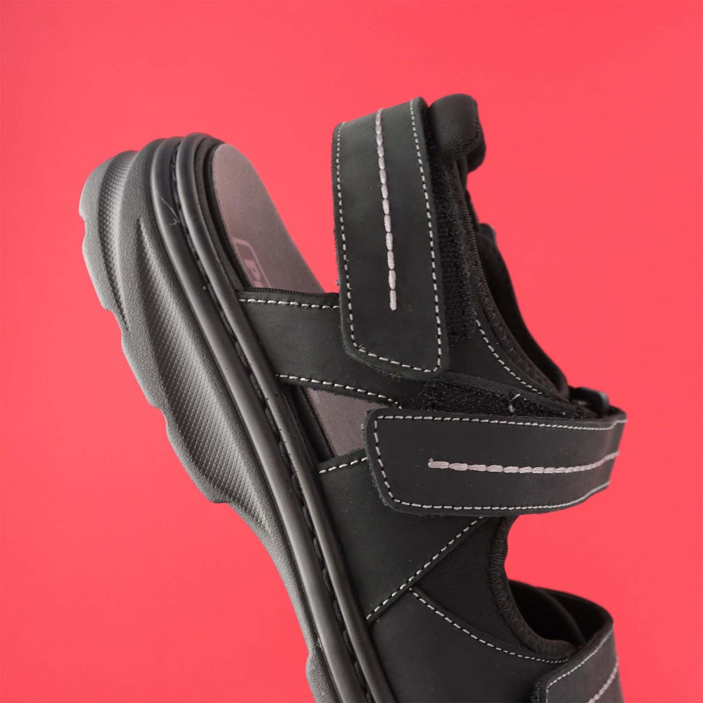 Angled side half view of Propet Hudson Sandal- Attractive leather design featuring contrast stitching and a thick, supportive outsole. Attractive leather design featuring contrast stitching and a thick, supportive outsole