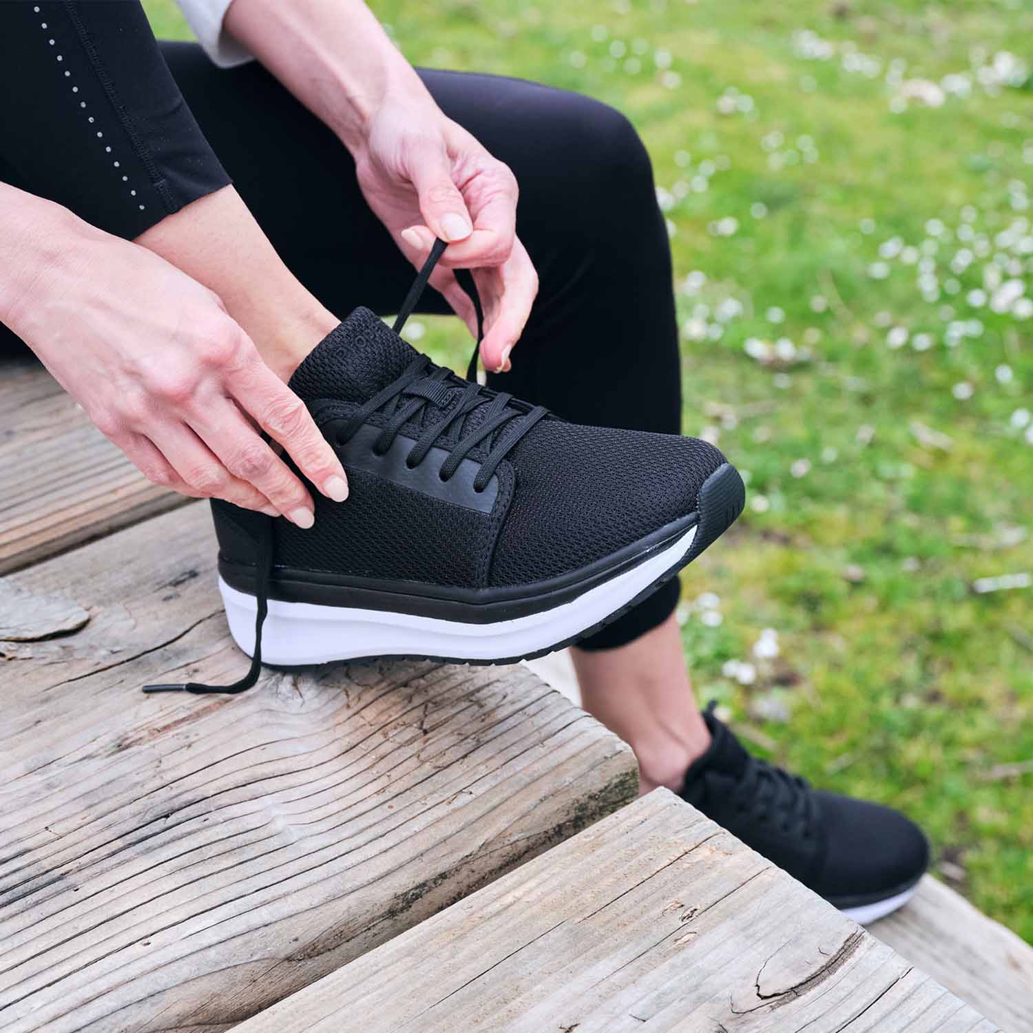 Person tying the laces on their Ultima X Athletic Shoes